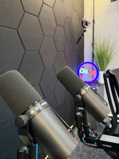 Two Shure SM7dB microphones under the ON AIR sign in the San Antonio podcast studio