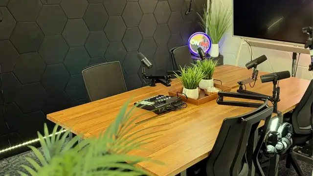 Four-person podcast table with acoustic hexagon paneling in San Antonio